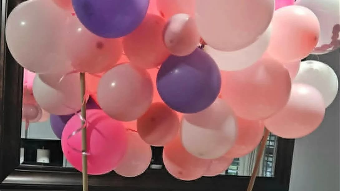Pink and purple balloon arrangement prepared for a gift basket