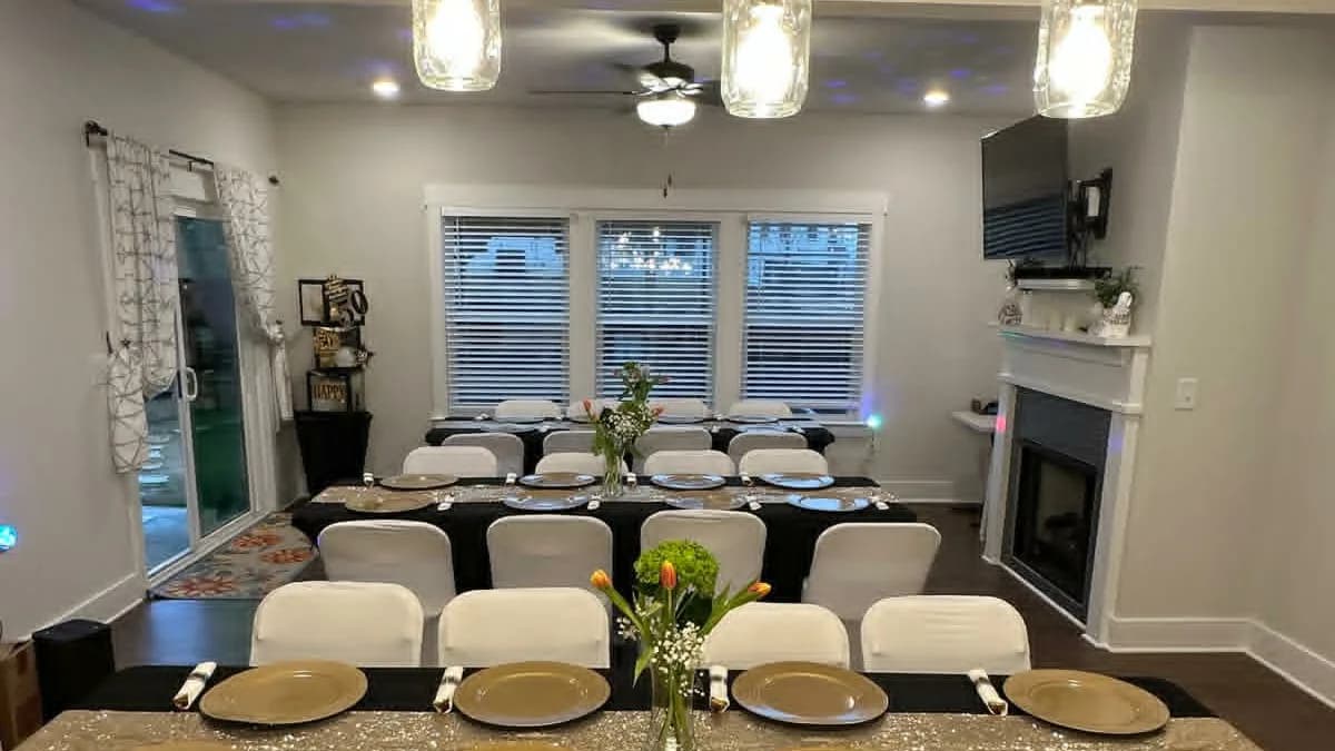 Dining tables prepared with chair covers, runners, and floral centerpieces
