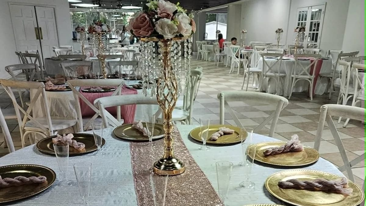 Pink and gold table settings in a decorated reception room
