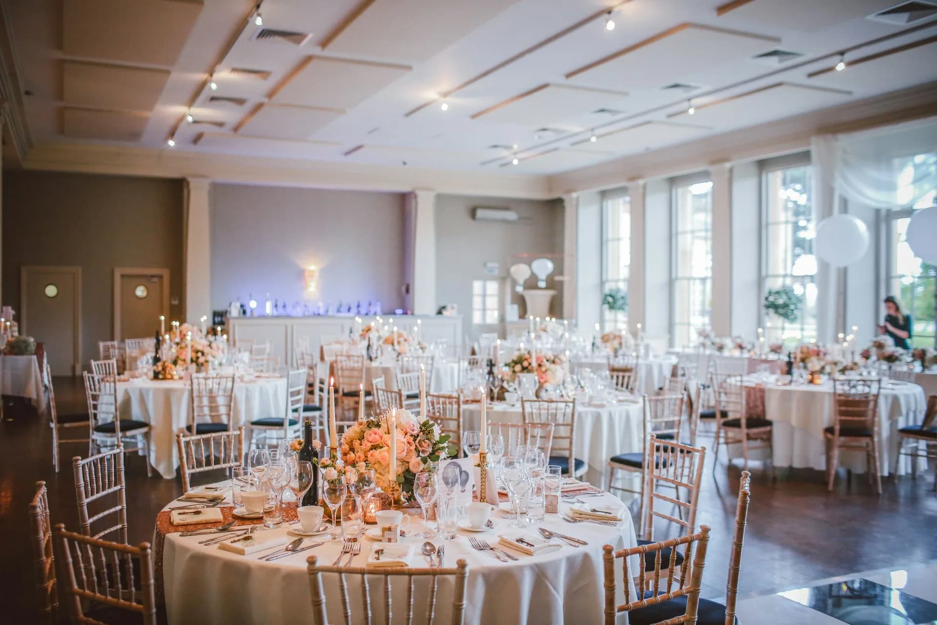 Elegant event venue with decorated tables and floral centerpieces