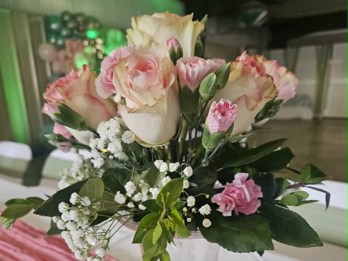 Pink and cream floral centerpiece on an event table