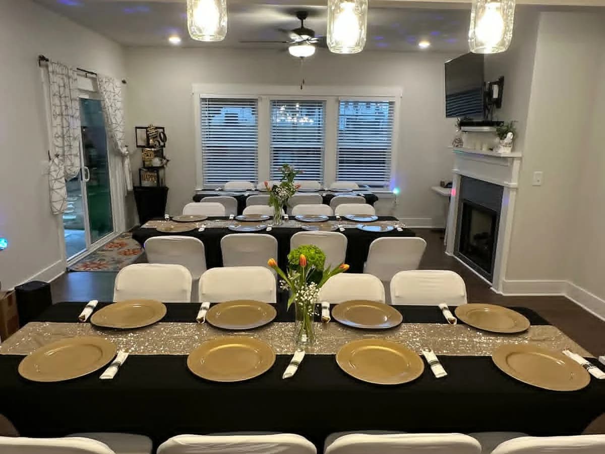 Multiple dining tables prepared with chair covers and place settings
