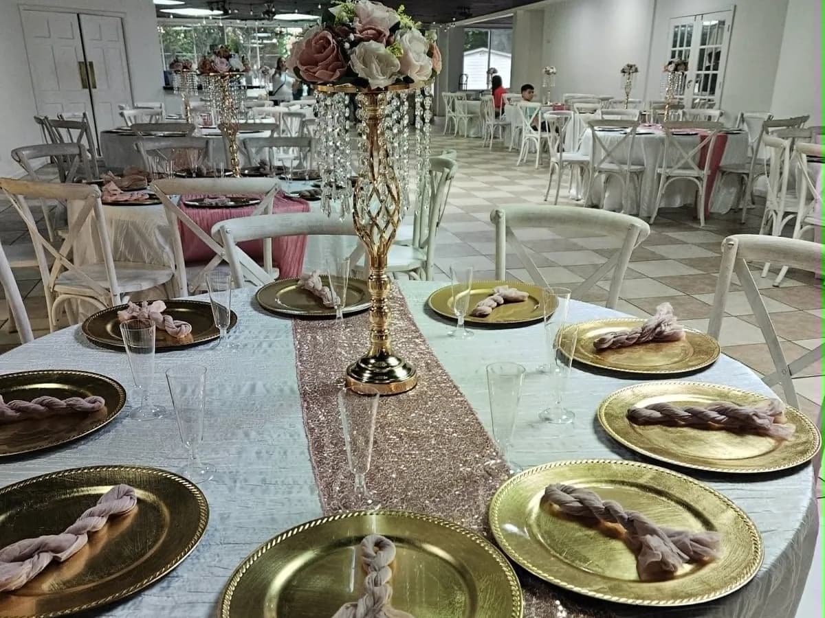 Pink and gold reception table with a tall floral centerpiece